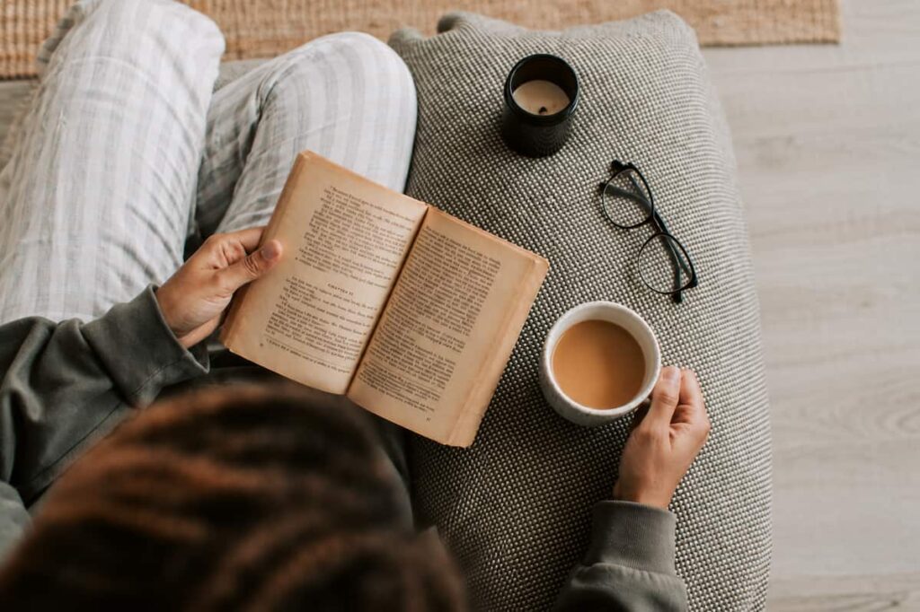 Reading a book while enjoying a cup of coffee