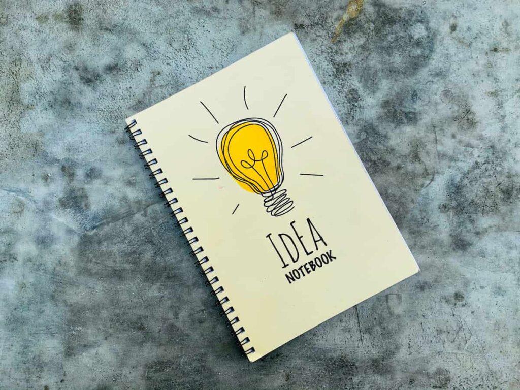 An idea notebook with a light bulb illustration on the cover, representing creative screen-free activities.