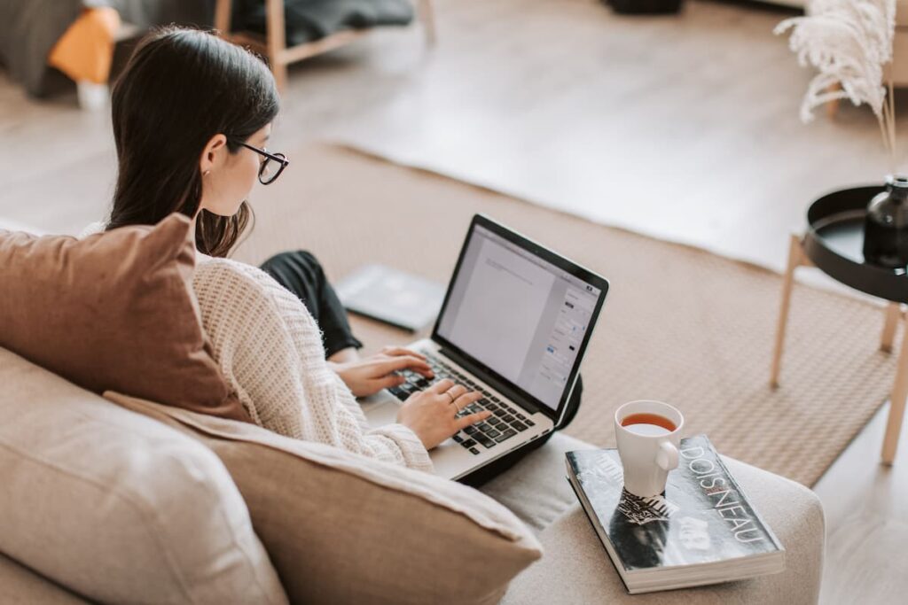 A lady working on her laptop from home, spending time focused on getting things done
